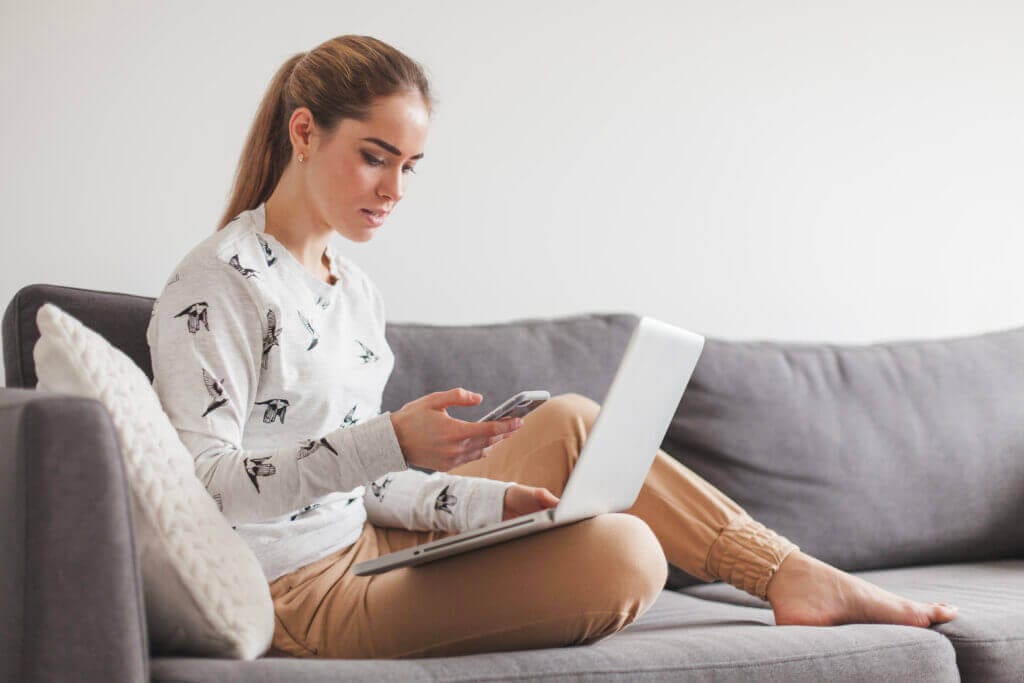 woman sitting couch with laptop
