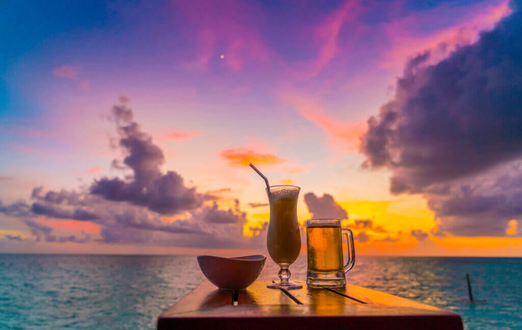 glass beer with beautiful tropical maldives island