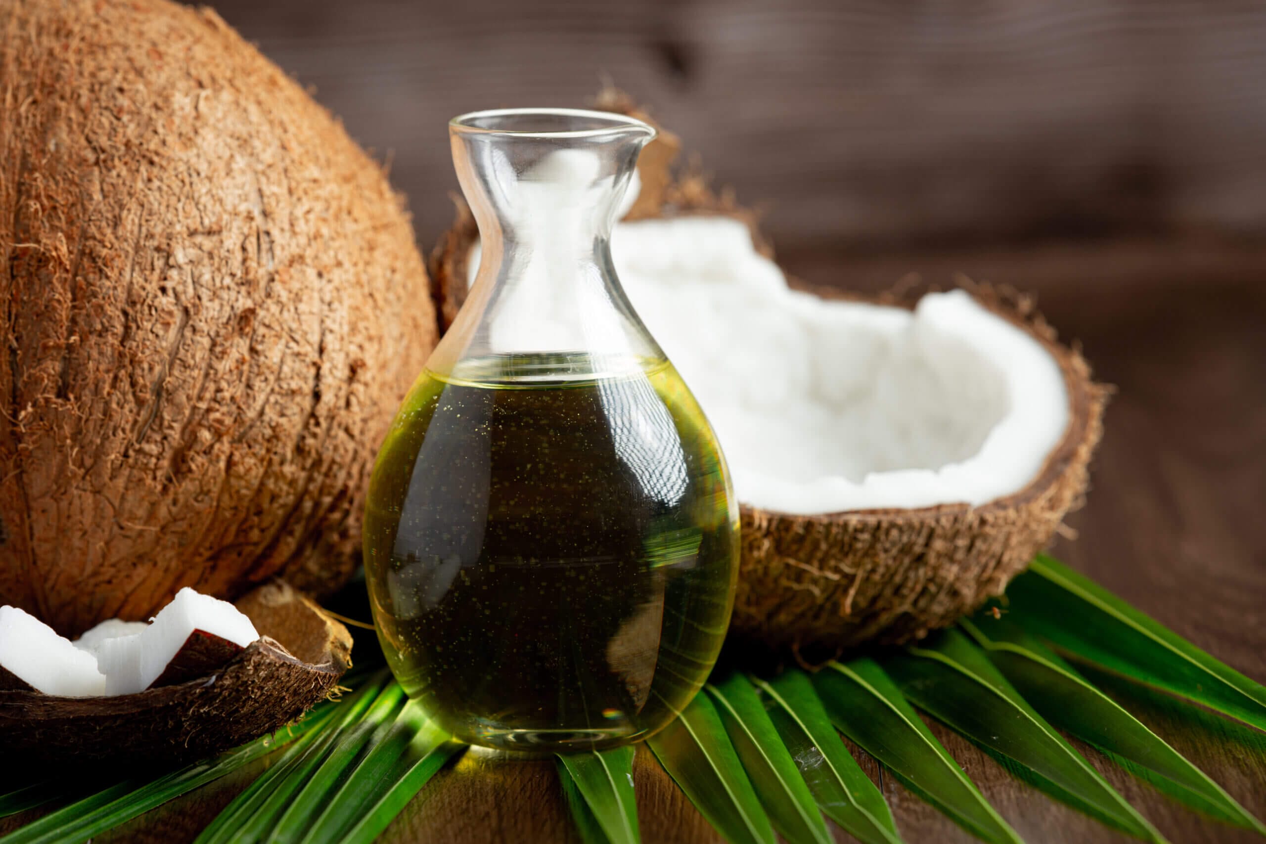 Jak poznat kvalitní kokosový olej jug coconut oil whit coconut put dark background scaled