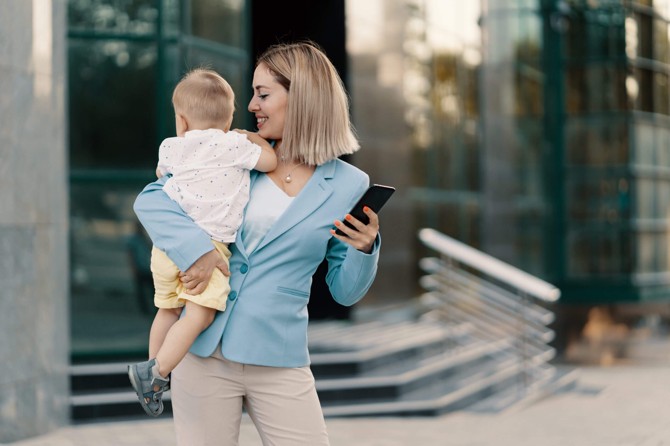 portrait successful business woman blue suit with baby scaled